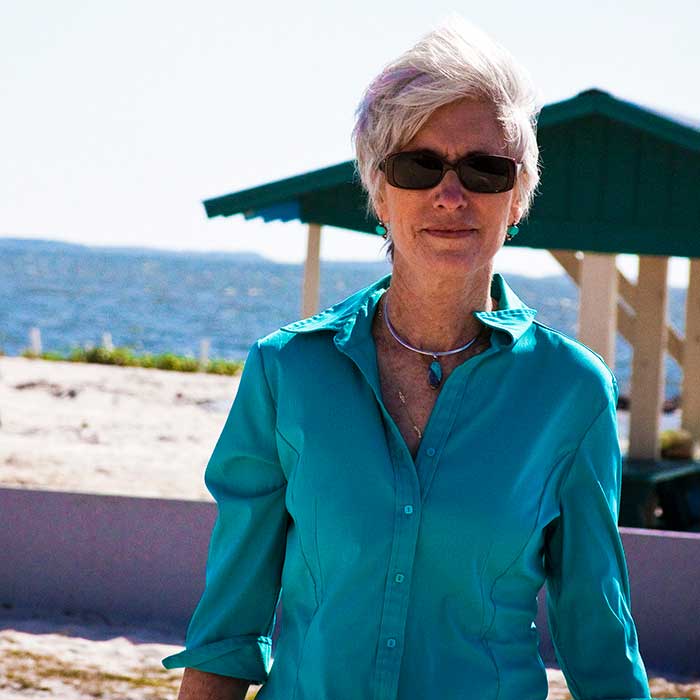 Senior lady clicking picture at beach