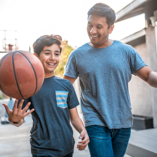 father and son playing basketball